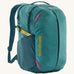 Patagonia turquoise 26L day refugio backpack on a cream background.