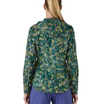 Patagonia women's houdini jacket in a turquoise colour with a retro flower design worn by a woman back detail