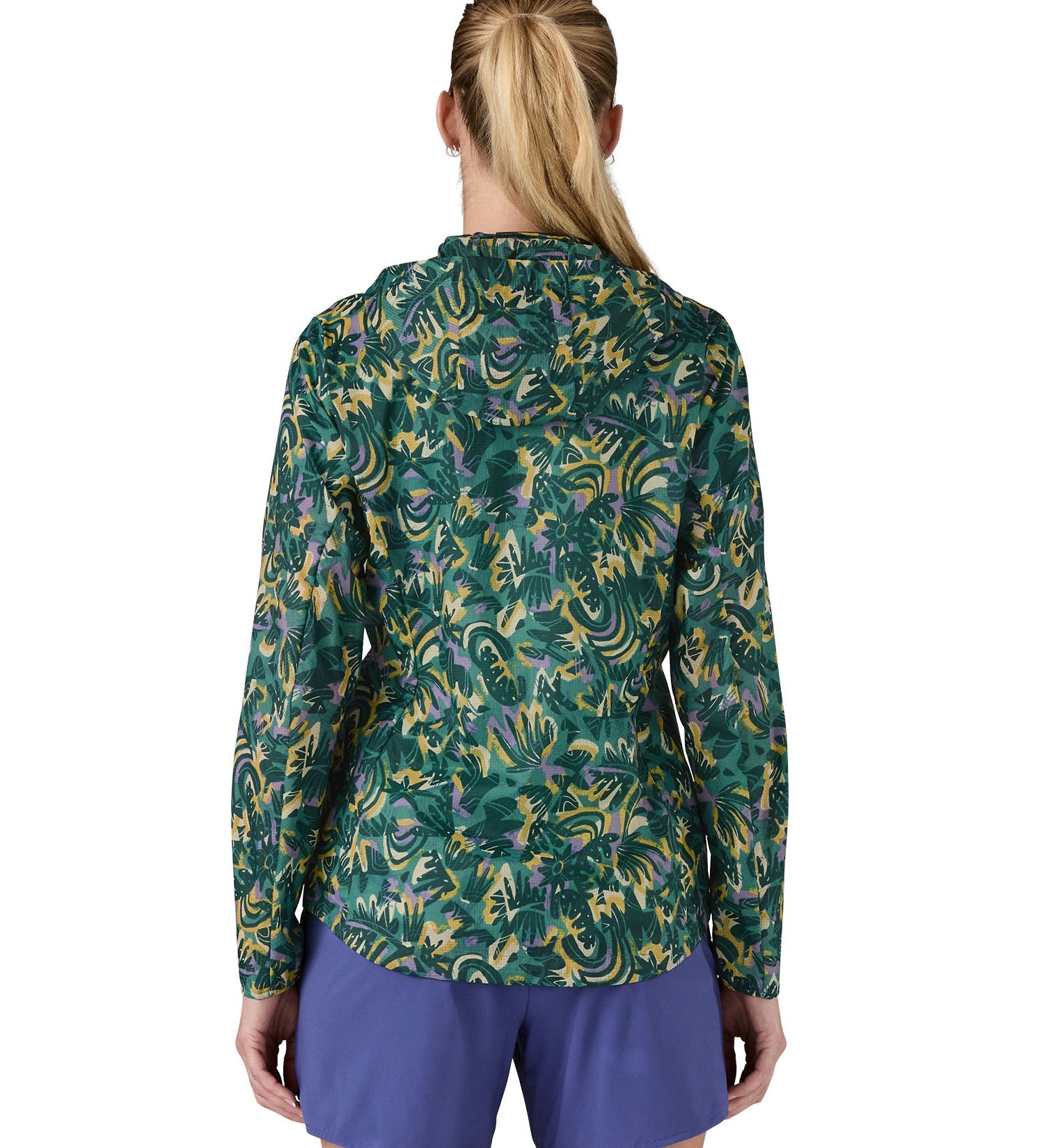 Patagonia women's houdini jacket in a turquoise colour with a retro flower design worn by a woman back detail