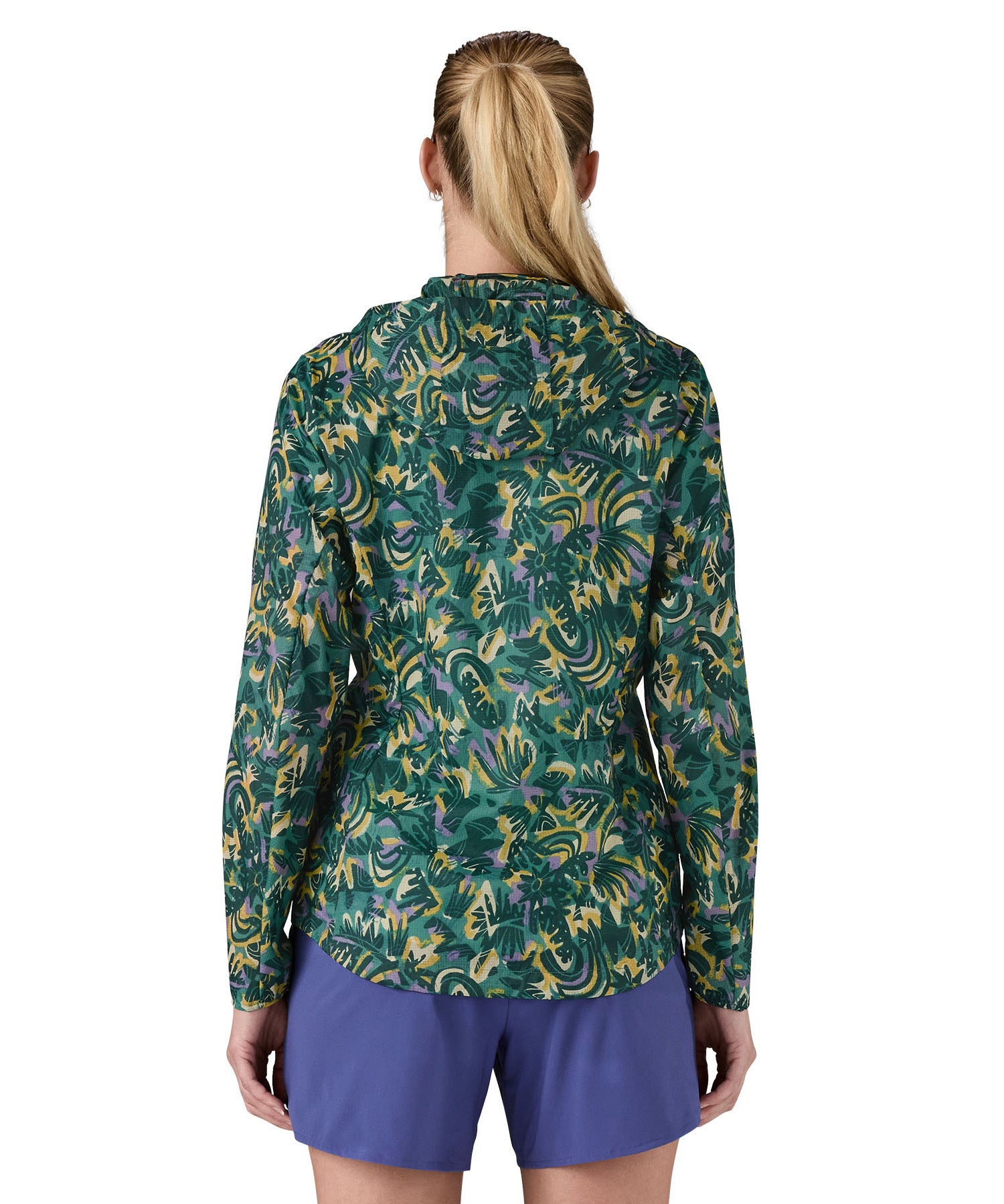 Patagonia women's houdini jacket in a turquoise colour with a retro flower design worn by a woman back detail