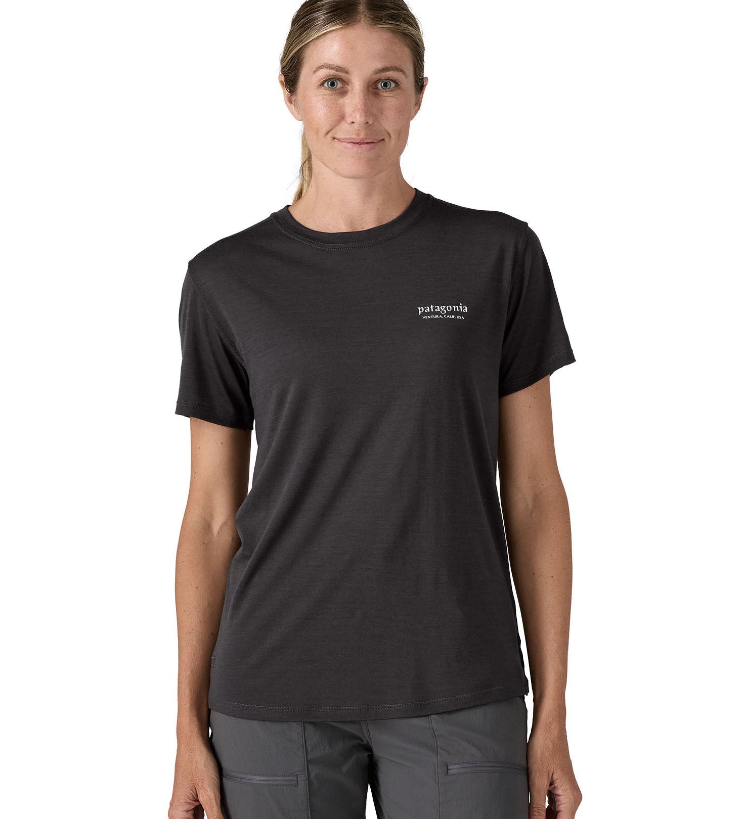 Woman wearing the Patagonia  women's black capilene merino blend t-shirt with small heritage header logo on chest.