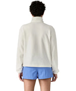 Back of woman wearing Patagonia women's microdini fleece in white. Fleece has a relaxed fit
