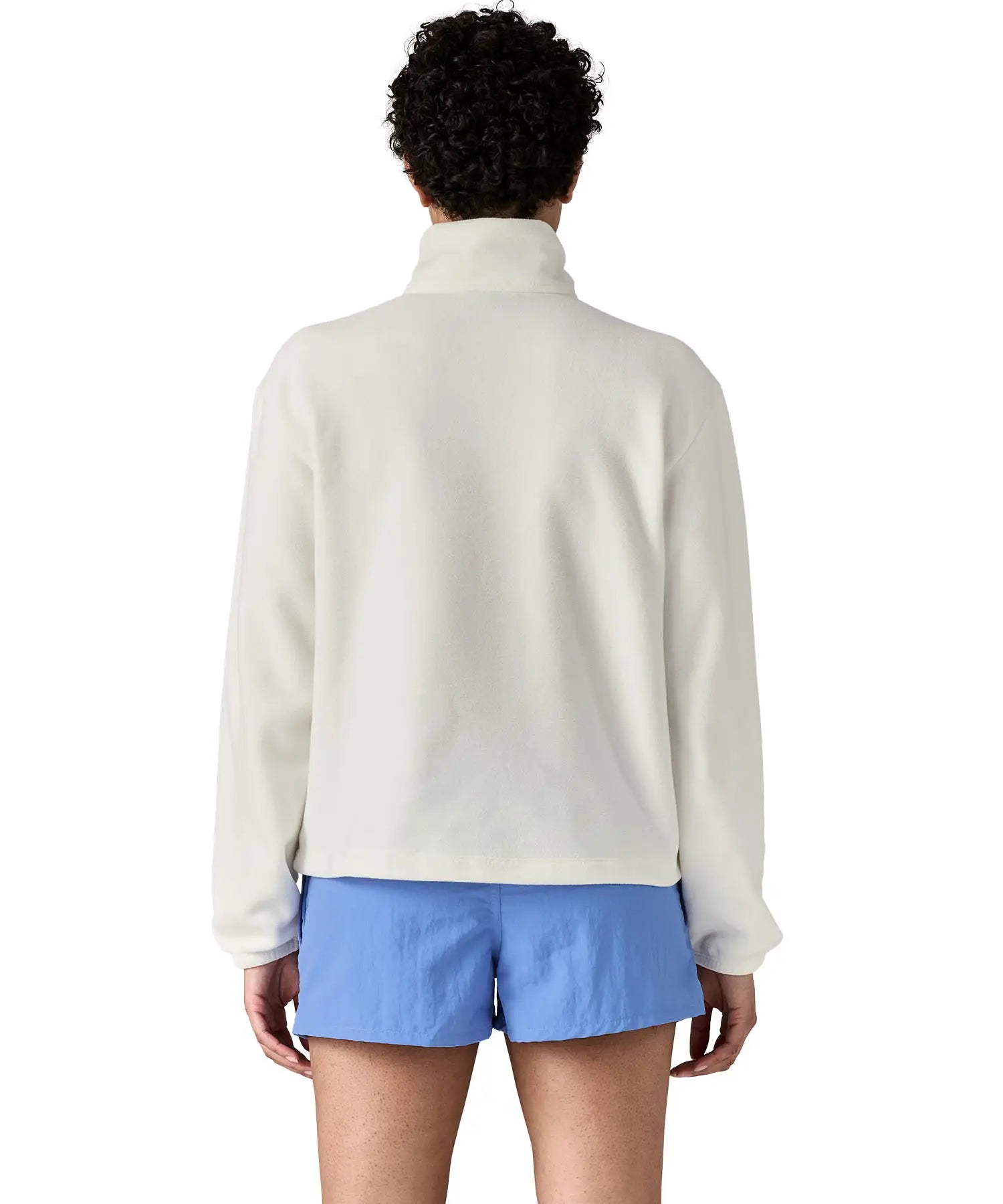 Back of woman wearing Patagonia women's microdini fleece in white. Fleece has a relaxed fit