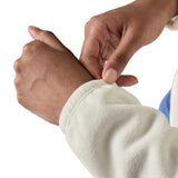 Woman pulling on the elasticated cuff Patagonia's women's microdini fleece jacket in white 