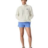 Front of woman wearing Patagonia women's microdini fleece  in white. Fleece has a relaxed fit and sits at the hips