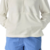 Woman wearing Patagonia women's microdini fleece in white showing hands in side pockets