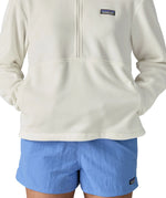 Woman wearing Patagonia women's microdini fleece in white showing hands in side pockets