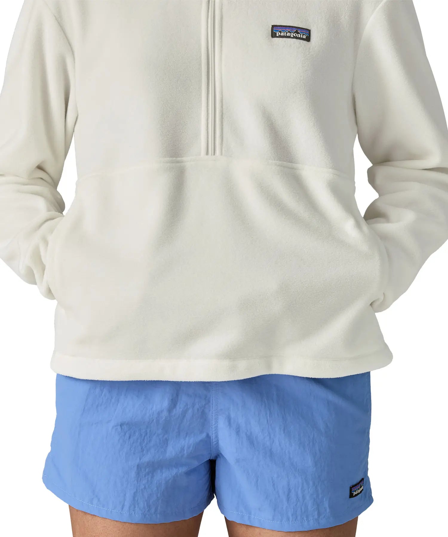 Woman wearing Patagonia women's microdini fleece in white showing hands in side pockets
