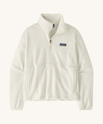 Patagonia women's micro 1/2 zip fleece in white on a cream background.