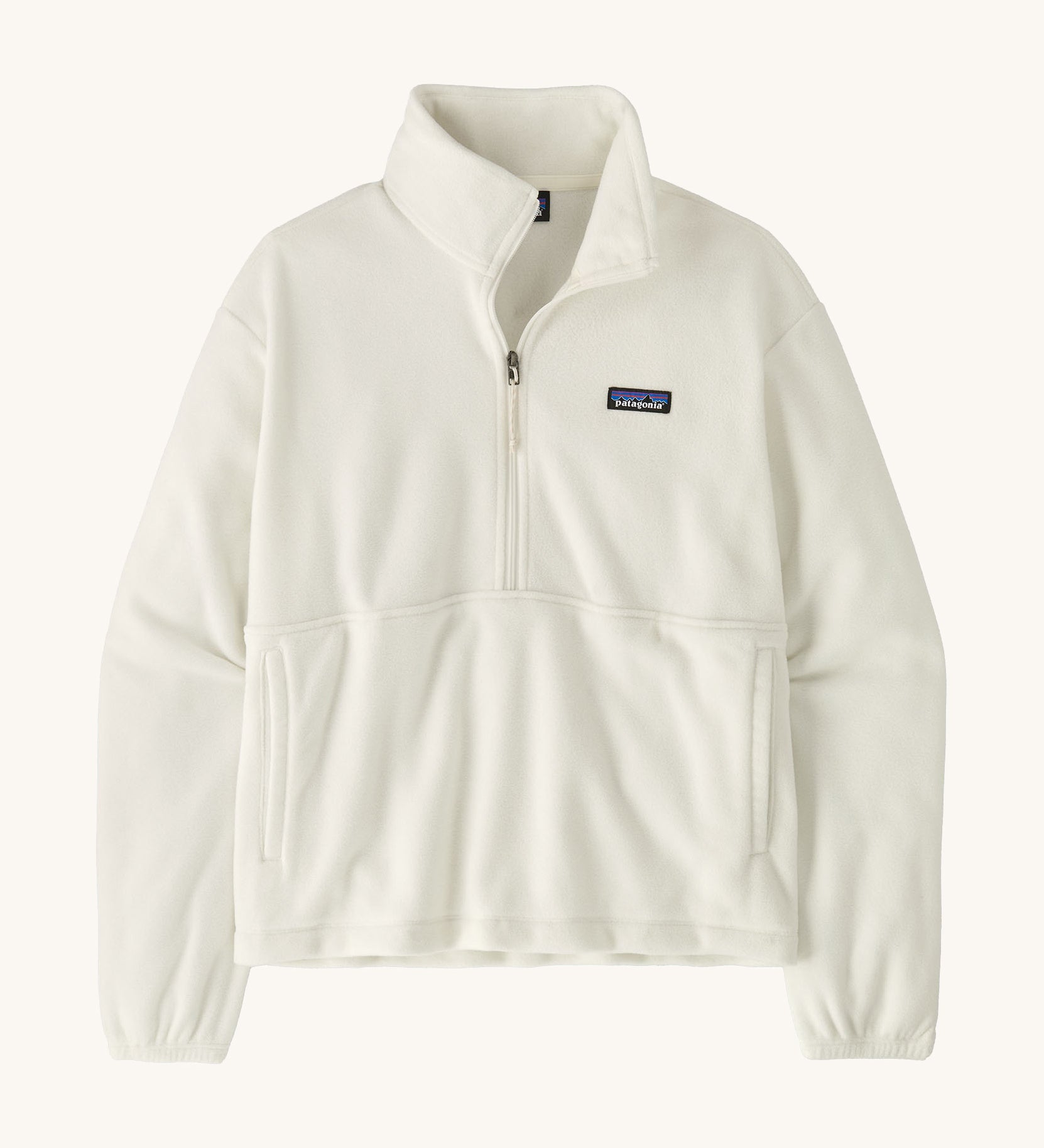 Patagonia women's micro 1/2 zip fleece in white on a cream background.