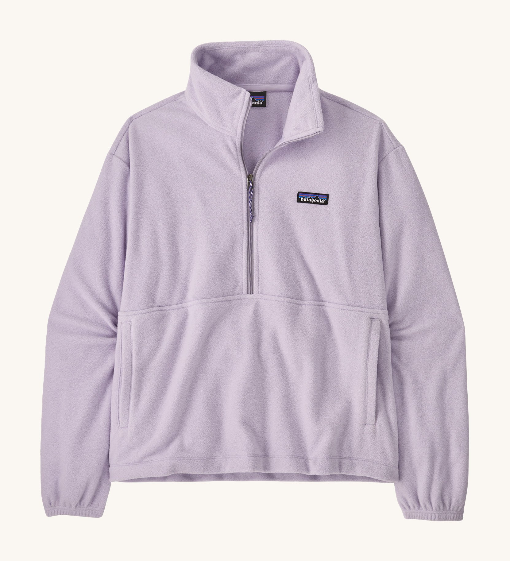 Patagonia women's micro 1/2 zip fleece in a light purple colour on a cream background.