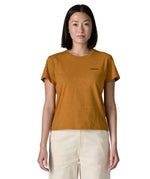 Woman wearing the Patagonia women's P-6 logo responsibili-tee short sleeved t-shirt in dried mango yellow with small logo on the chest.