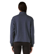 A view of the back of a woman wearing a dark grey blue coloured Patagonia Women's Ahnya Pullover.