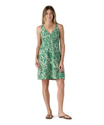 Model wearing the Patagonia organic  cotton knee-length dress with a green pattern.