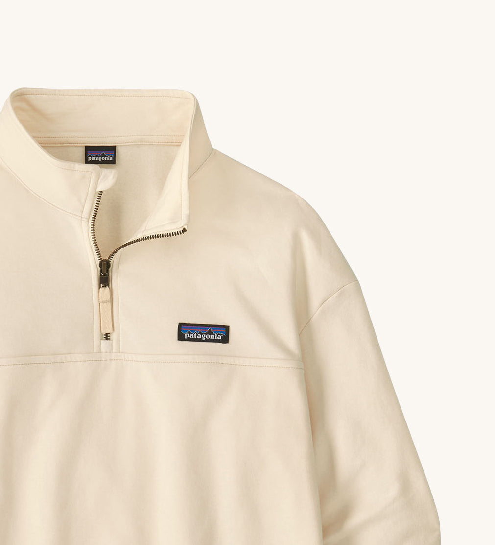 A close up of the Patagonia women's Anya pullover available at Babipur showing the 1/4 zip detail. Features a brand patch on the chest.