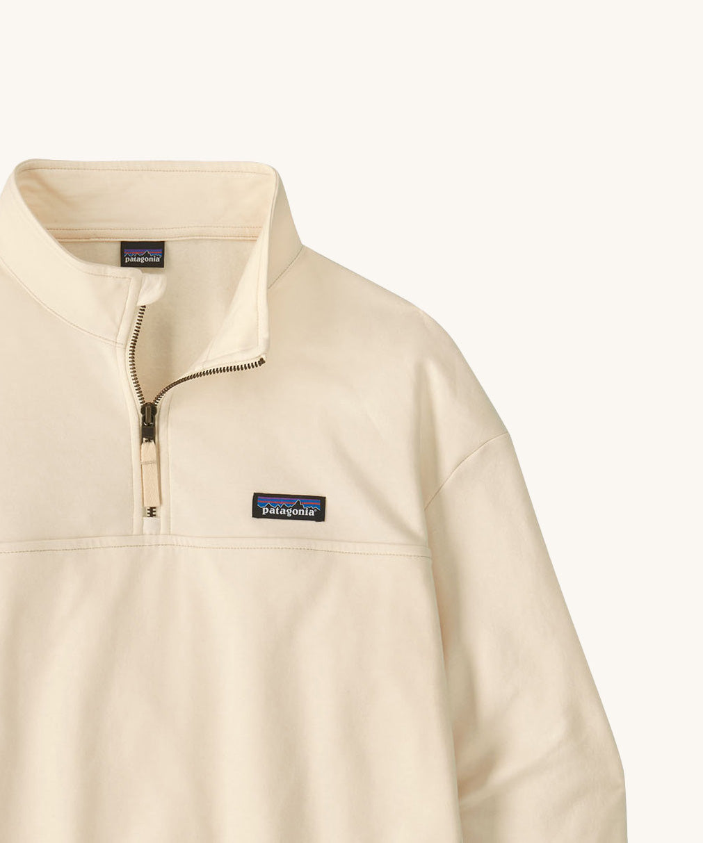 A close up of the Patagonia women's Anya pullover available at Babipur showing the 1/4 zip detail. Features a brand patch on the chest.