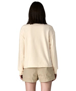 Back of woman wearing a cream Patagonia Women's Ahnya Pullover. Pullover has a relaxed fit