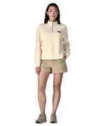 Woman wearing a cream Patagonia Women's Ahnya Pullover. Pullover has a relaxed fit and sits at the hips 