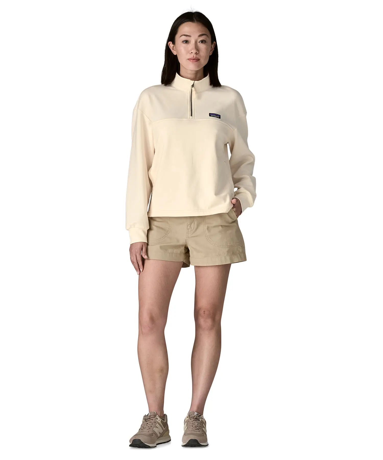Woman wearing a cream Patagonia Women's Ahnya Pullover. Pullover has a relaxed fit and sits at the hips 