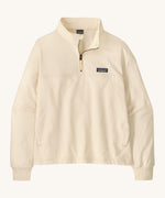Patagonia women's Anya pullover. A cream lightweight pullover, features a 1/4 length zip, easy access side pockets and the logo patch stitched on the left chest.