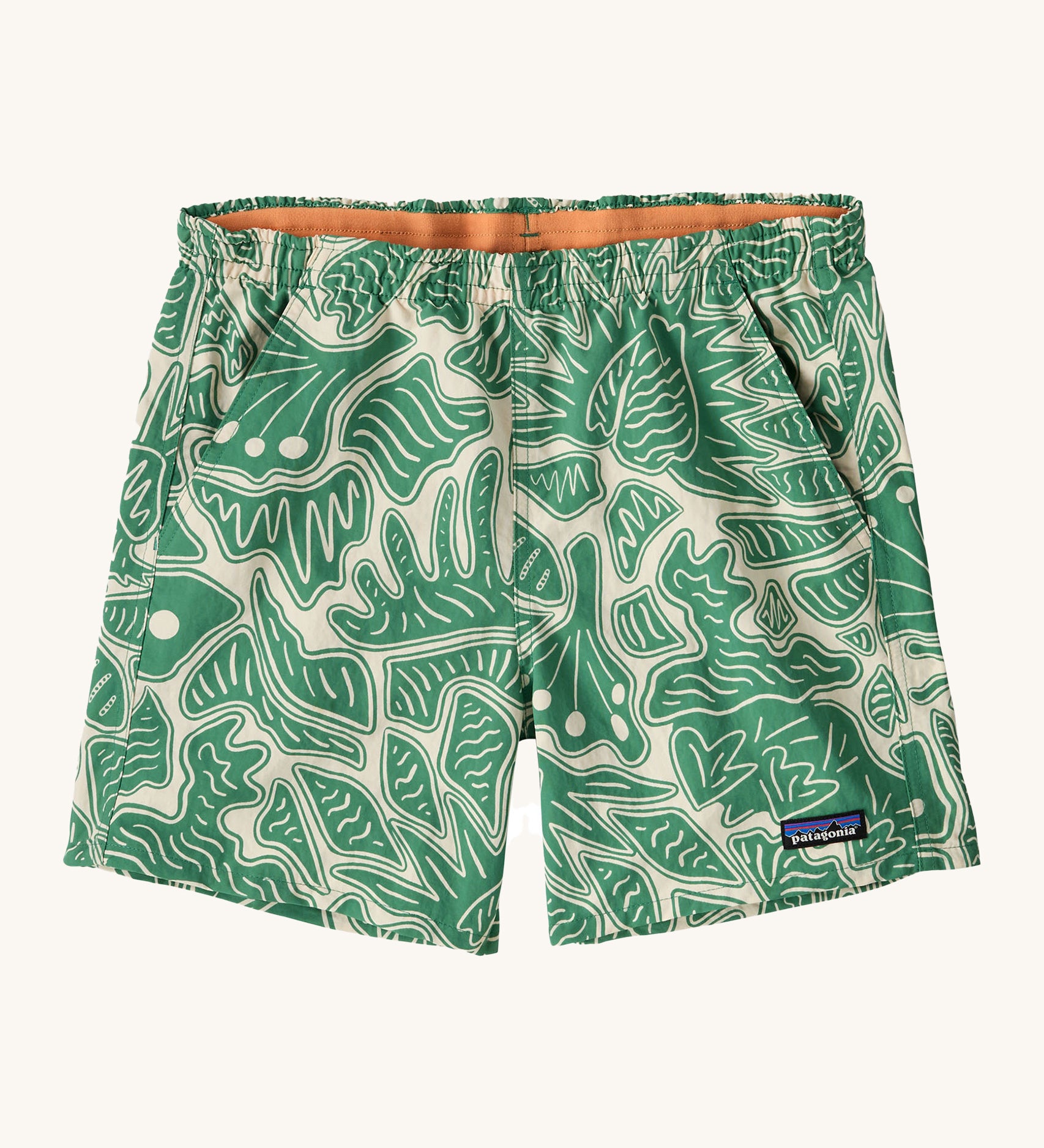 Patagonia women's baggies shorts with a retro green leaf design on a cream background.