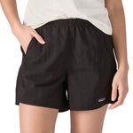 Patagonia women's baggies shorts in black worn by a woman front pocket detail 