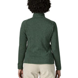 Back of woman wearing the Patagonia women’s better sweater fleece jacket in green. Close up of collar with zip open.