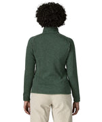 Back of woman wearing the Patagonia women’s better sweater fleece jacket in green. Close up of collar with zip open.