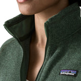 Woman wearing the Patagonia women’s better sweater fleece jacket in green. Close up of collar with zip open.