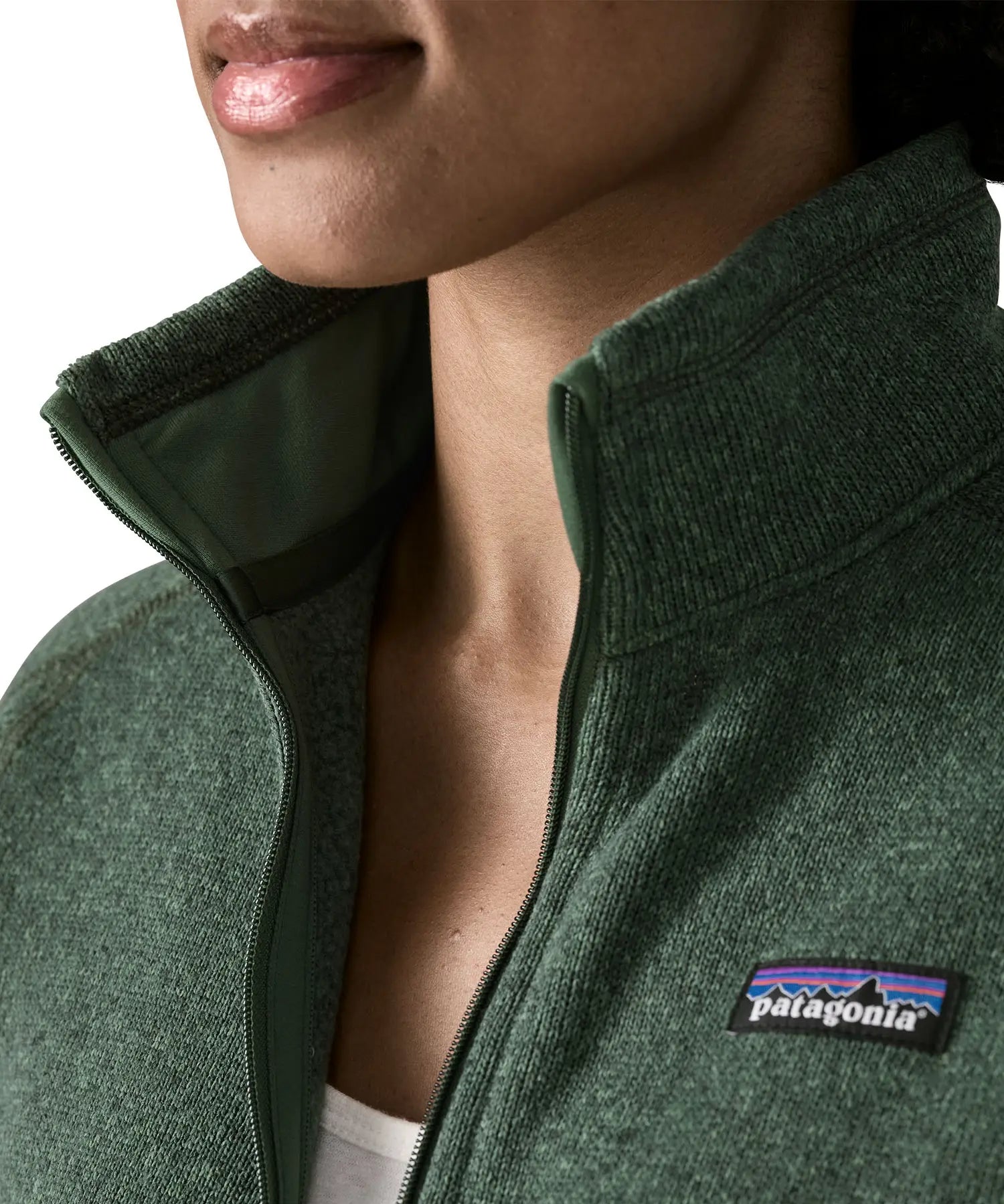 Woman wearing the Patagonia women’s better sweater fleece jacket in green. Close up of collar with zip open.