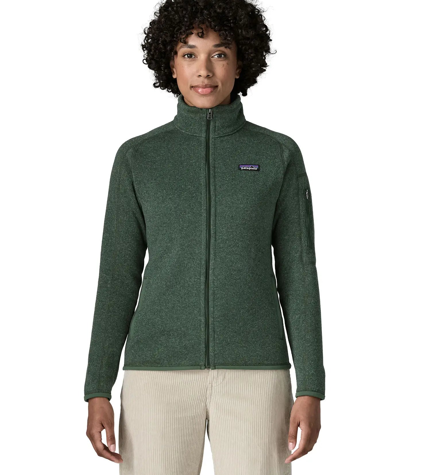 Woman wearing the Patagonia women’s better sweater fleece jacket in green. Full zip jacket with zipped arm pocket and handwarmer pockets.
