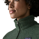 Woman wearing the Patagonia women’s better sweater fleece jacket in green. Close up of collar with zip closed.
