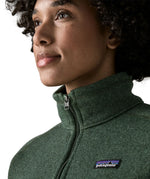 Woman wearing the Patagonia women’s better sweater fleece jacket in green. Close up of collar with zip closed.