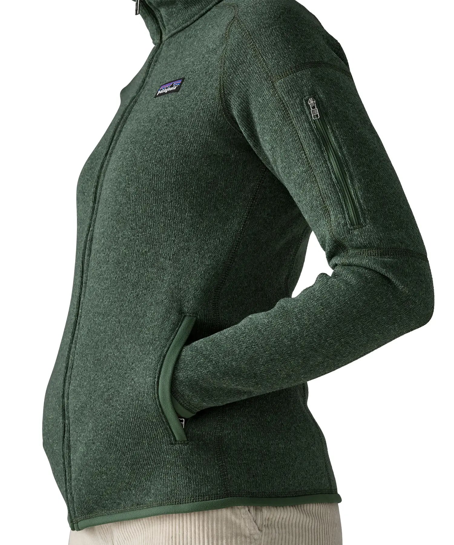 Side of woman wearing the Patagonia women’s better sweater fleece jacket in green. Full zip jacket with zipped arm pocket and handwarmer pockets.