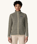 A woman wearing the Patagonia Women's Better Sweater Jacket with a scales pattern. The front zip is fully closed. We have a wide selection of Patagonia adults and children's clothing here at Babipur. 
