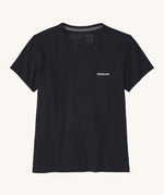 Patagonia women's short sleeve top in black showing the logo text printed on the left chest