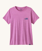 The front of the Patagonia Women's Capilene Cool Daily Graphic Shirt - '73 Skyline / Brisk Purple available at Babipur. A vibrant pink/purple top with short sleeves and a brand graphic on the chest