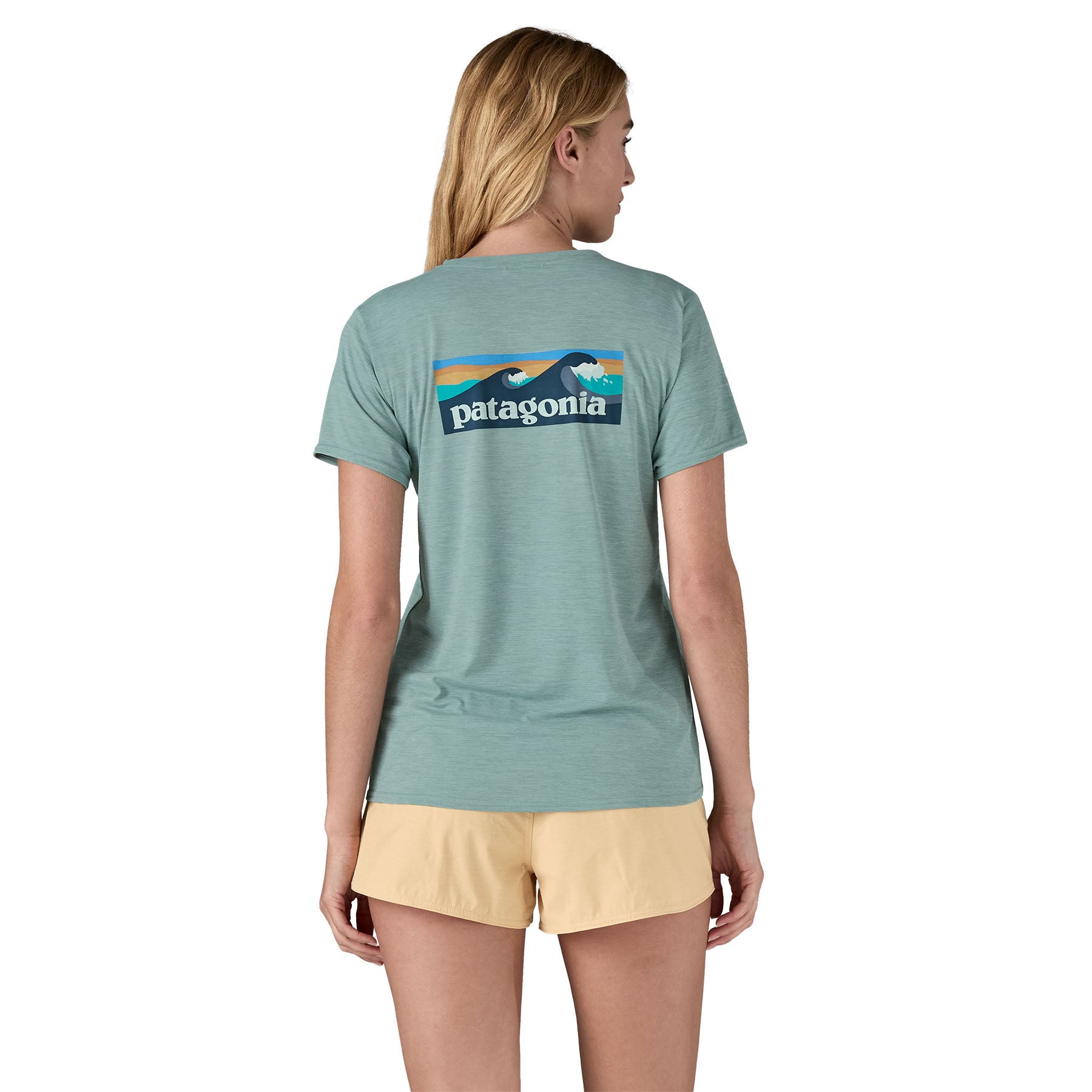 The back of a woman wearing the Patagonia Women's Cap Cool Daily Graphic Shirt in a Waters Thermal Blue colour available at Babipur 