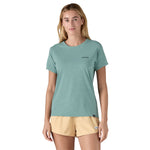 A woman wearing the Patagonia Women's Cap Cool Daily Graphic Shirt in a Waters Thermal Blue colour available at Babipur 