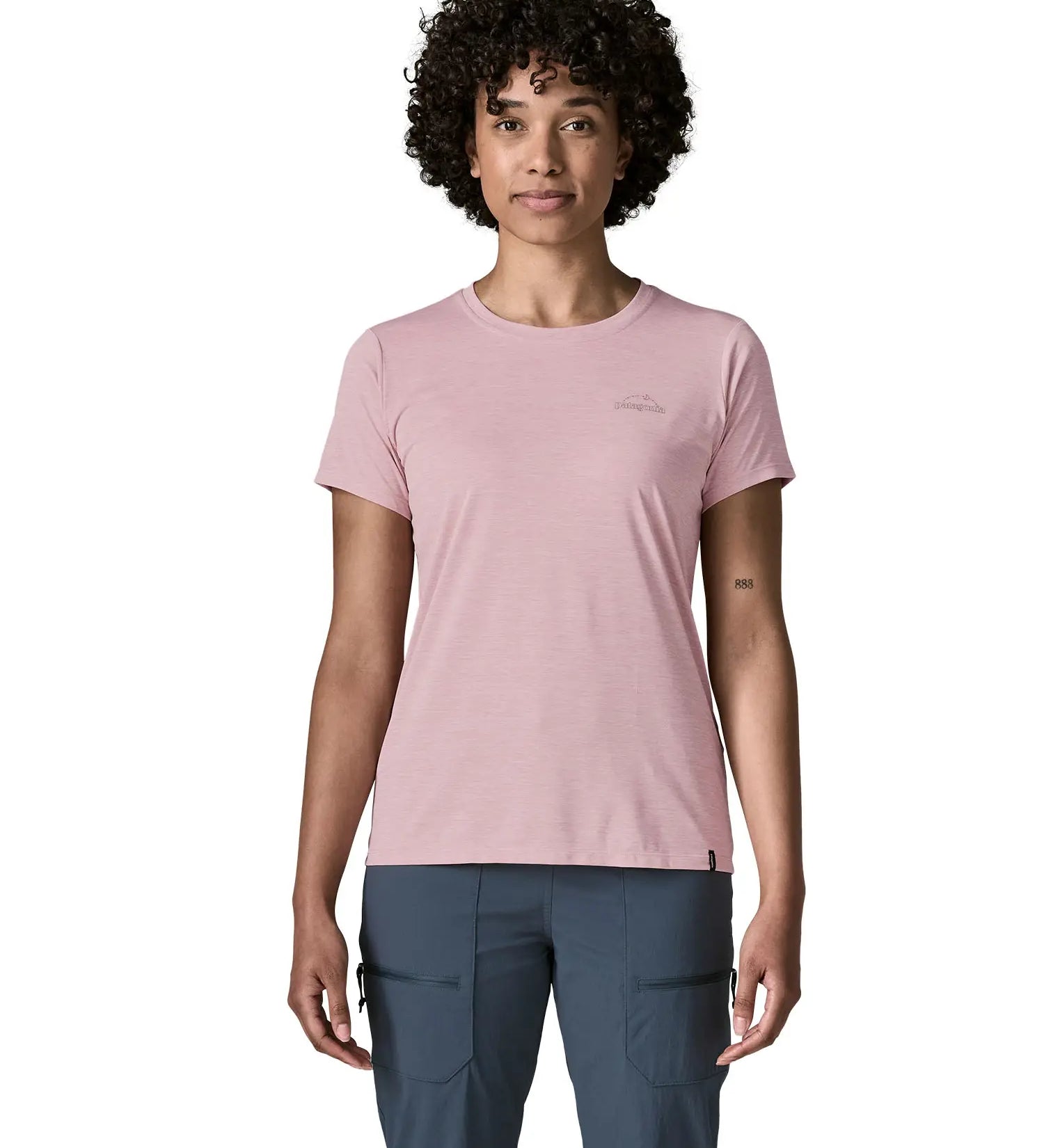 Woman wearing the Patagonia women's capilene cool daily shirt with P-6 Cosmos logo in Fuzzy Mauve pink with Light Fuzzy Mauve X-Dye material.