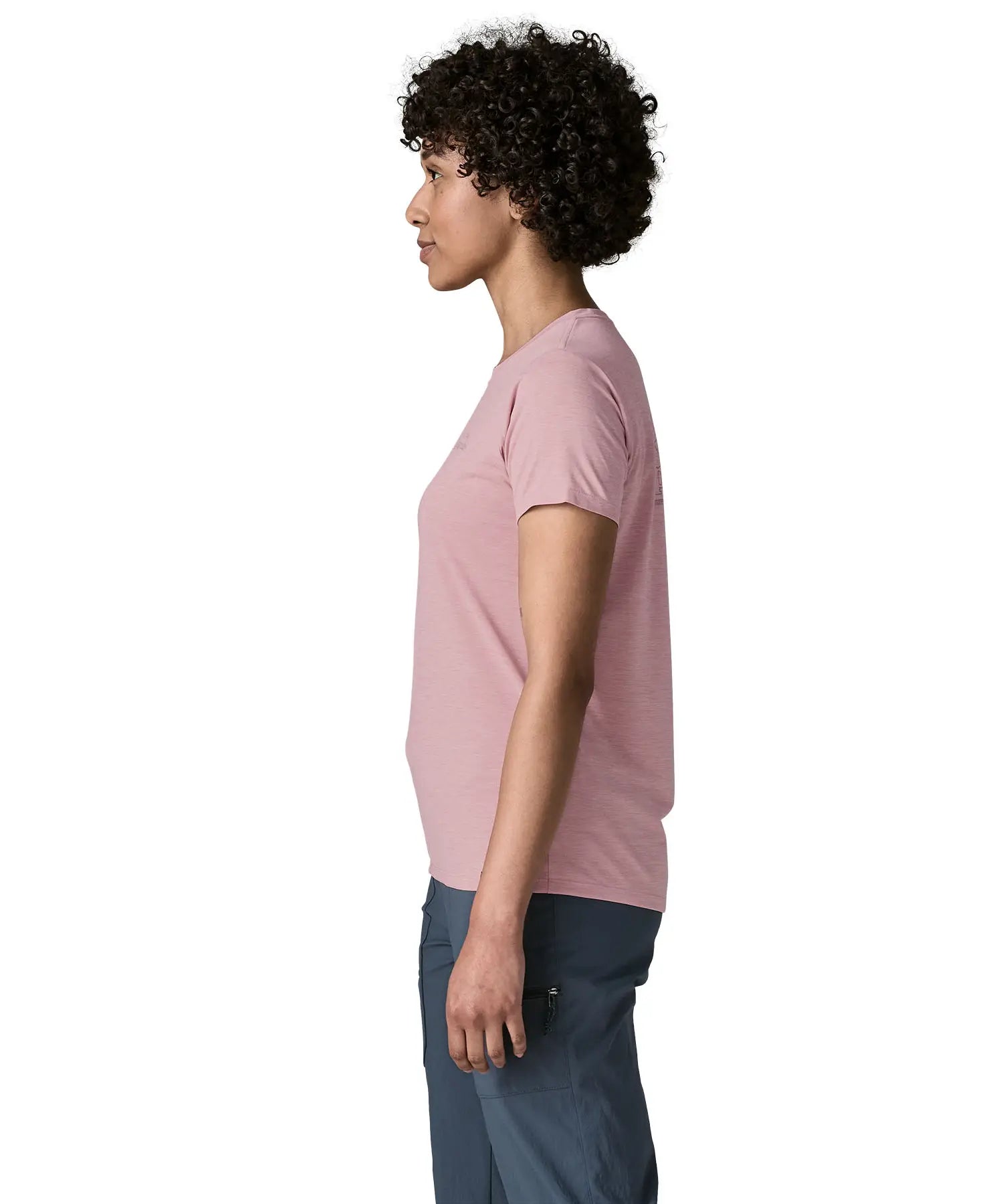 Side of woman wearing the Patagonia women's capilene cool daily shirt with P-6 Cosmos logo in Fuzzy Mauve pink with Light Fuzzy Mauve X-Dye material.