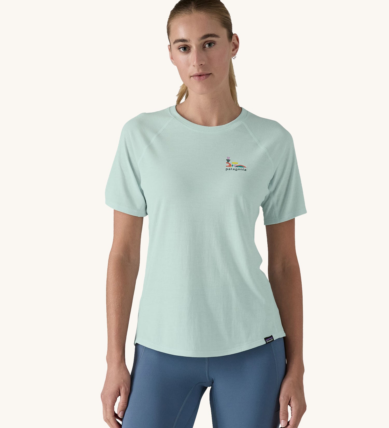 A woman wearing the Patagonia Women's Capilene Cool Trail Graphic Shirt in a Wispy Green colour. 