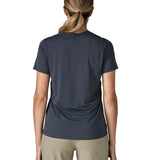 Back of of woman wearing Patagonia women's capilene cool ultra short sleeve t-shirt in navy. T-shirt has a relaxed fit