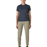 Woman wearing Patagonia women's capilene cool ultra short sleeve t-shirt in navy. T-shirt has a relaxed fit and sits at the hips