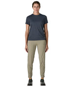 Woman wearing Patagonia women's capilene cool ultra short sleeve t-shirt in navy. T-shirt has a relaxed fit and sits at the hips