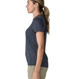 Side of woman wearing Patagonia women's capilene cool ultra short sleeve t-shirt in navy.