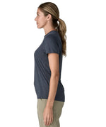Side of woman wearing Patagonia women's capilene cool ultra short sleeve t-shirt in navy.