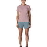 Woman wearing the Patagonia women's capilene short sleeve t-shirt in violet with small pink trailcheck graphic on the chest.