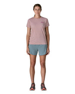 Woman wearing the Patagonia women's capilene short sleeve t-shirt in violet with small pink trailcheck graphic on the chest.