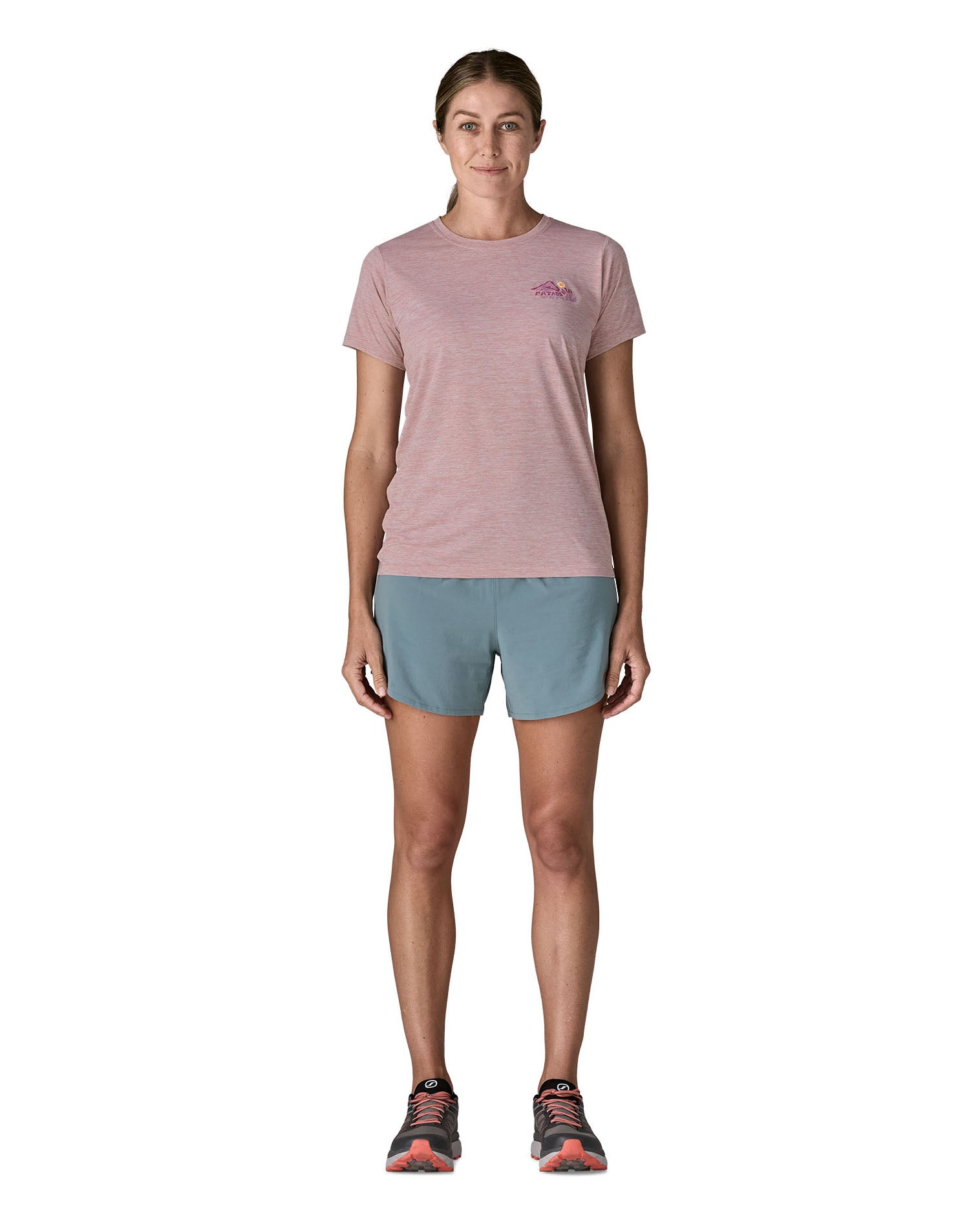 Woman wearing the Patagonia women's capilene short sleeve t-shirt in violet with small pink trailcheck graphic on the chest.